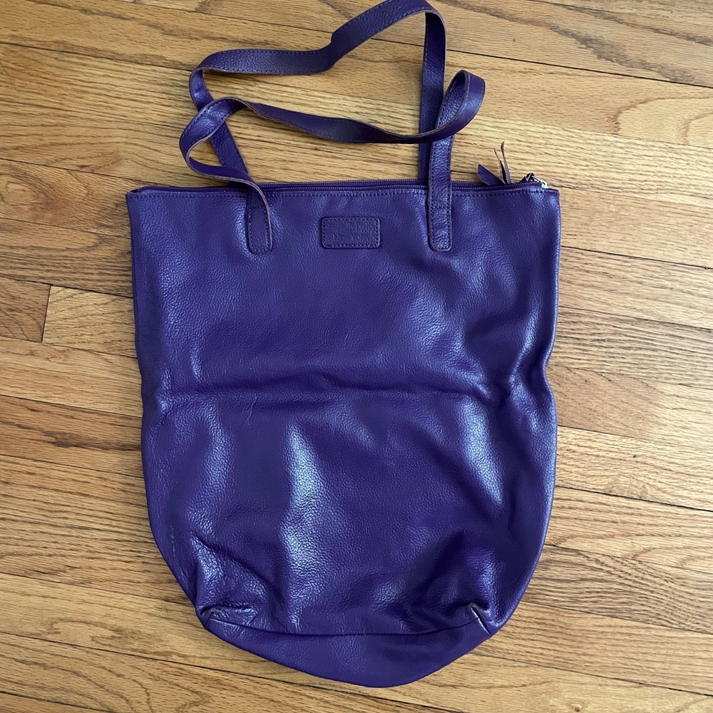 Leather, purple bag with small interior pocket.